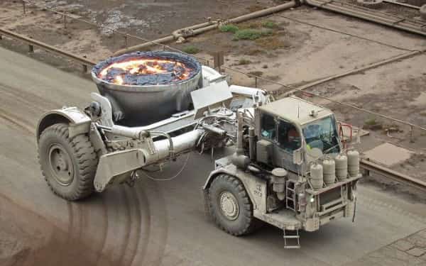 Industrial slag carrier truck transporting molten metal that looks like a giant bowl of soup.