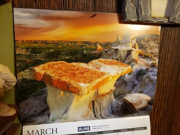 Rock formation in a calendar photo resembling a grilled cheese sandwich or piece of toast.