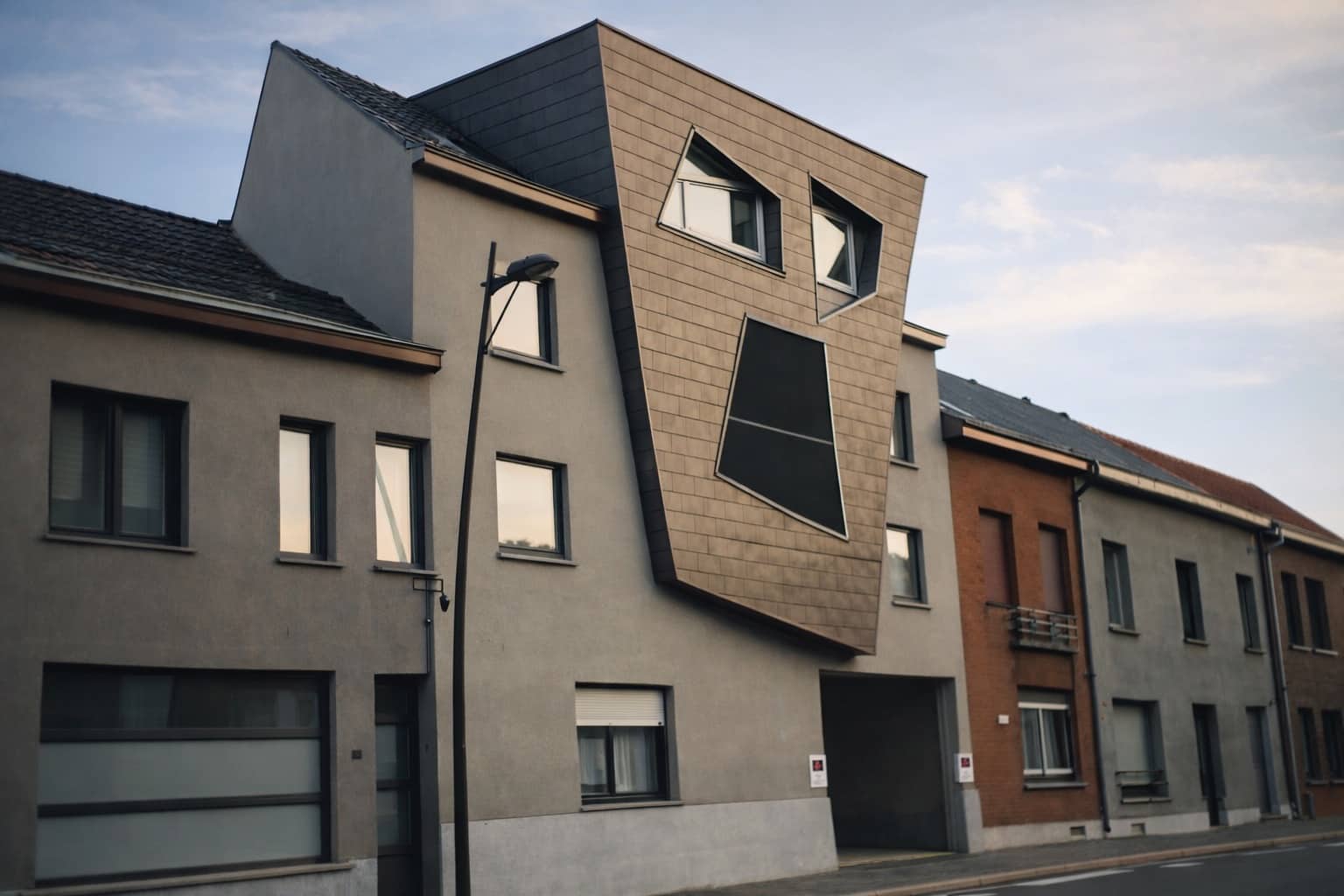 Unique modern Belgian house architecture with a facade resembling a giant screaming face for weirdest houses.