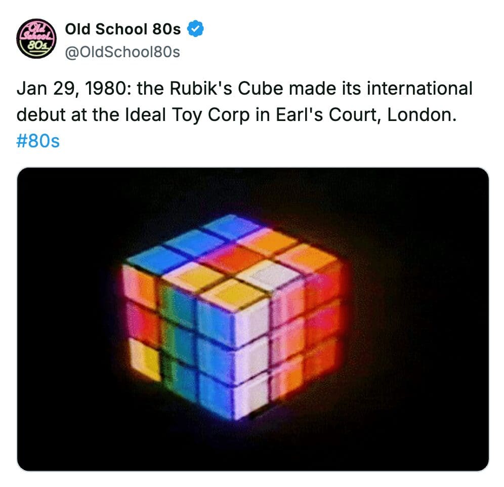 A colorful Rubik's Cube glowing against a dark background celebrating its 1980 international debut.