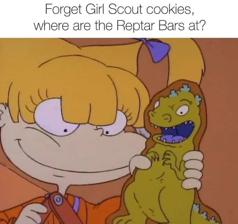 Angelica Pickles from Rugrats holding a Reptar Bar and questioning why anyone wants Girl Scout cookies.