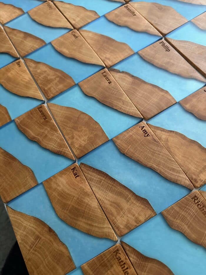 Custom wooden puzzle map interlocking engraved names with light blue epoxy resin rivers.