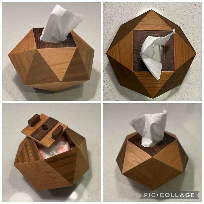 Faceted geometric wooden tissue box cover showing complex joinery and contrasting wood grains.