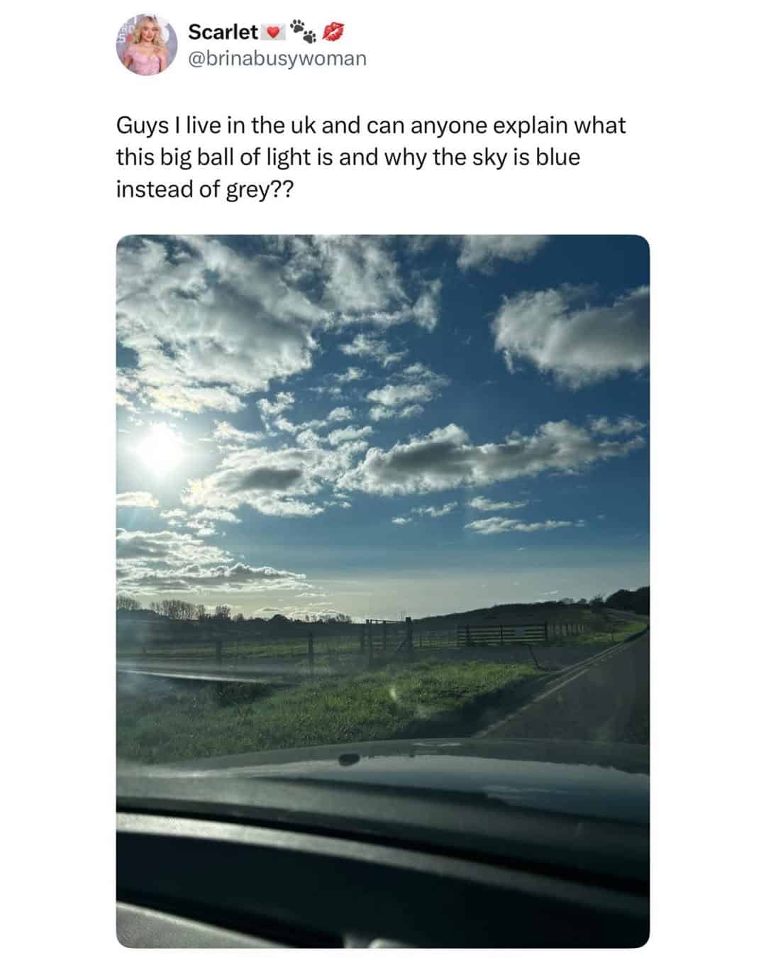 A view from a car of a rare sunny blue sky over the British countryside.