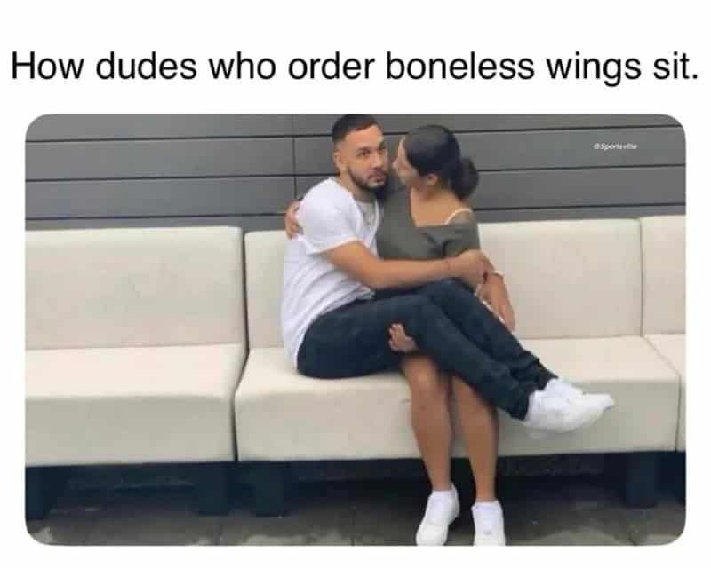 Humorous image of a man sitting in a woman's lap with a caption about boneless wing fans.