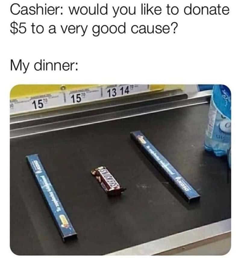 A lone Snickers bar on a grocery conveyor belt representing a person's entire dinner purchase.