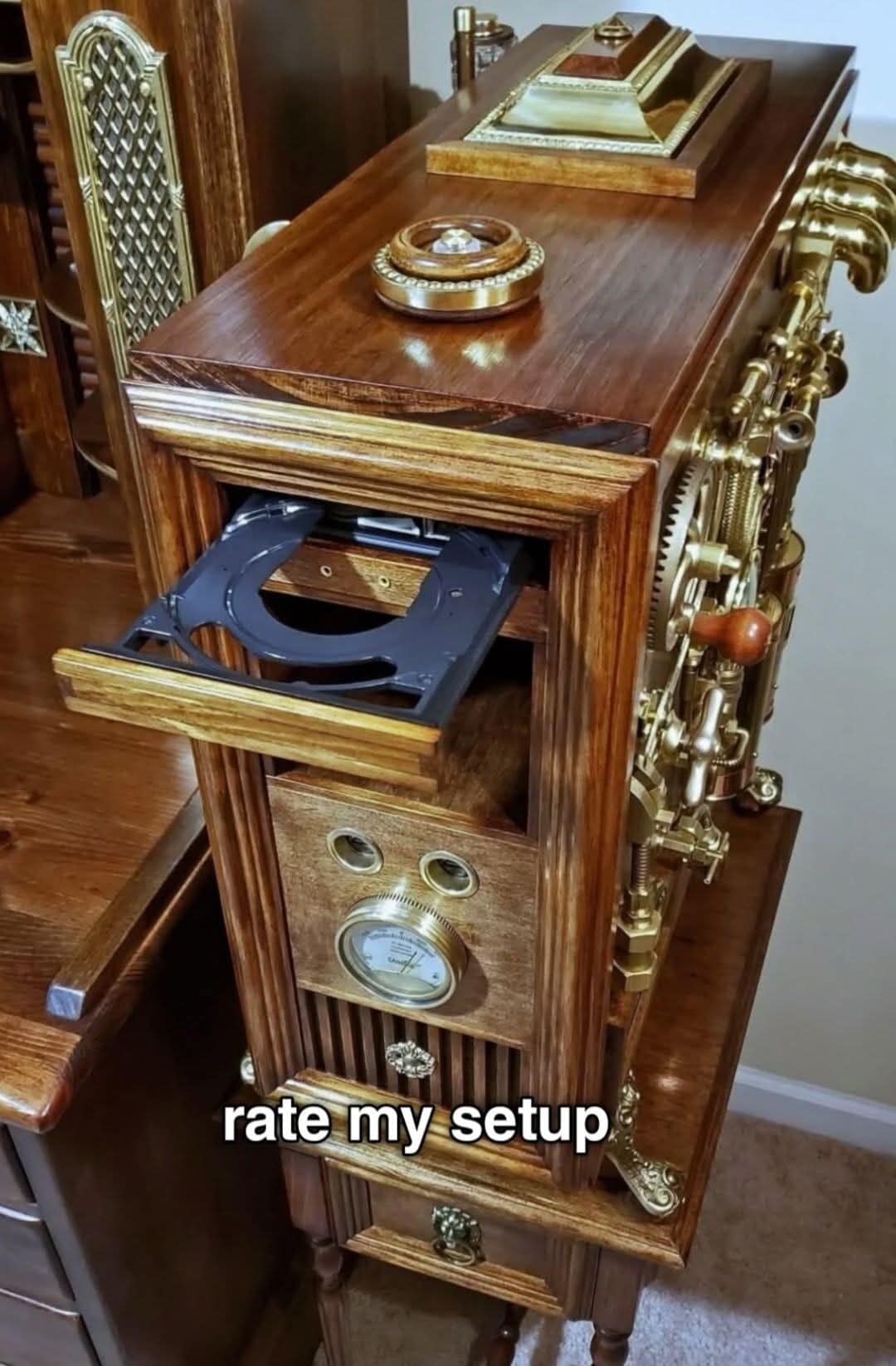 A classic meme showing a steampunk computer case made of wood and brass gears with a CD tray ejecting, captioned "rate my setup."