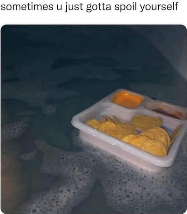 A peak struggle-meal old meme showing a grim, dark bathtub with a plastic lunchable tray of plain tortilla chips and cheese dip floating in the murky water, tragically captioned "sometimes u just gotta spoil yourself".