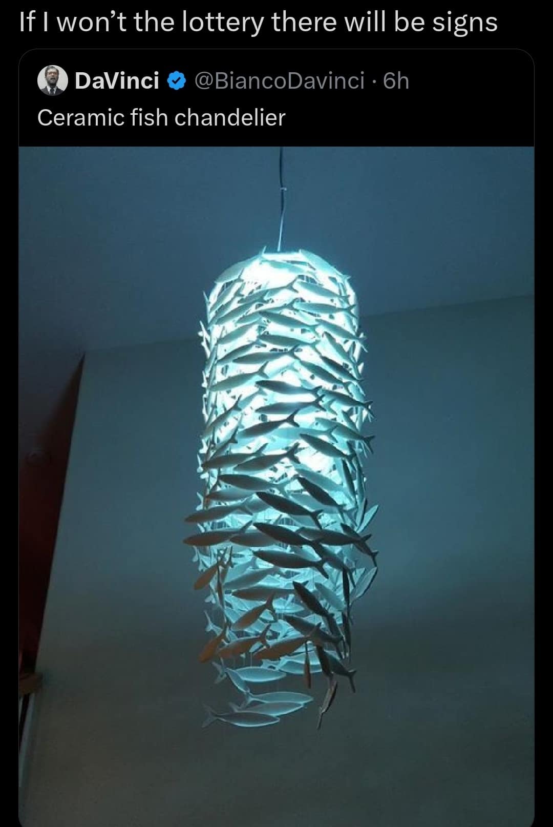 A bizarre interior design old meme featuring a massive, glowing, cylindrical chandelier made entirely of dozens of overlapping ceramic fish, captioned as the ultimate weird purchase sign of a person secretly winning the lottery.