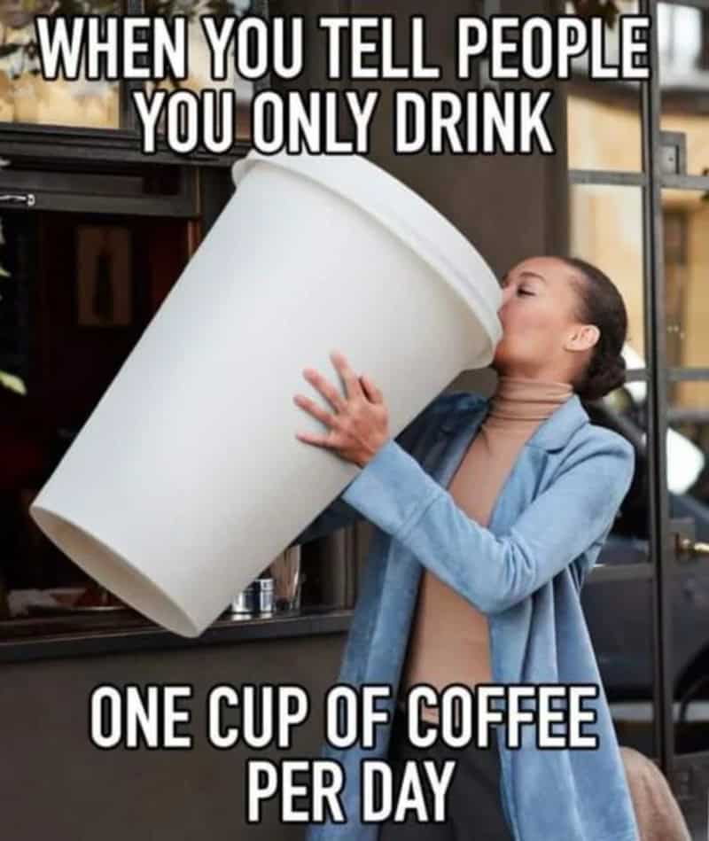 Coffee meme: A woman outdoors lifting and drinking from a giant, person-sized white coffee cup. Text: "WHEN YOU TELL PEOPLE YOU ONLY DRINK ONE CUP OF COFFEE PER DAY"