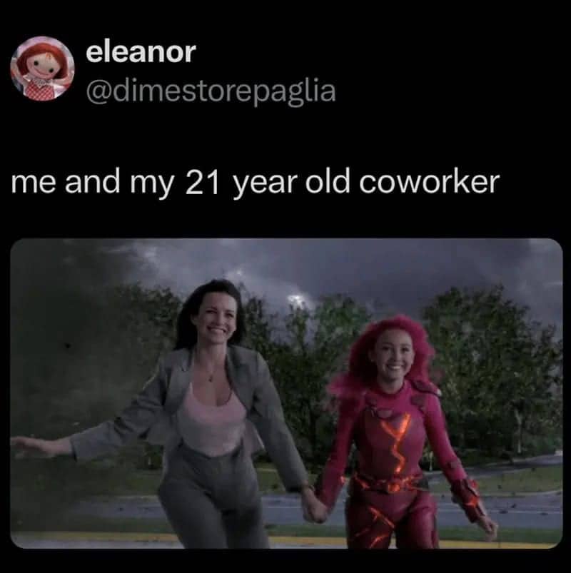 A professional woman in a suit walking next to Sharkboy and Lavagirl’s Lavagirl character.