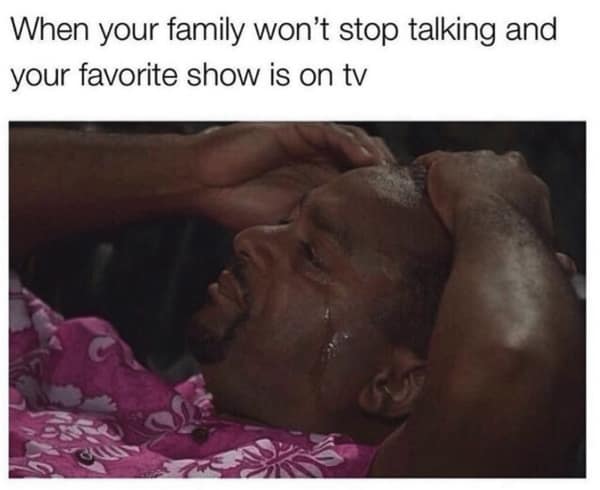 A relatable memes about family reaction image showing a man gripping his head in agony because his family refuses to stop talking during his favorite TV show.