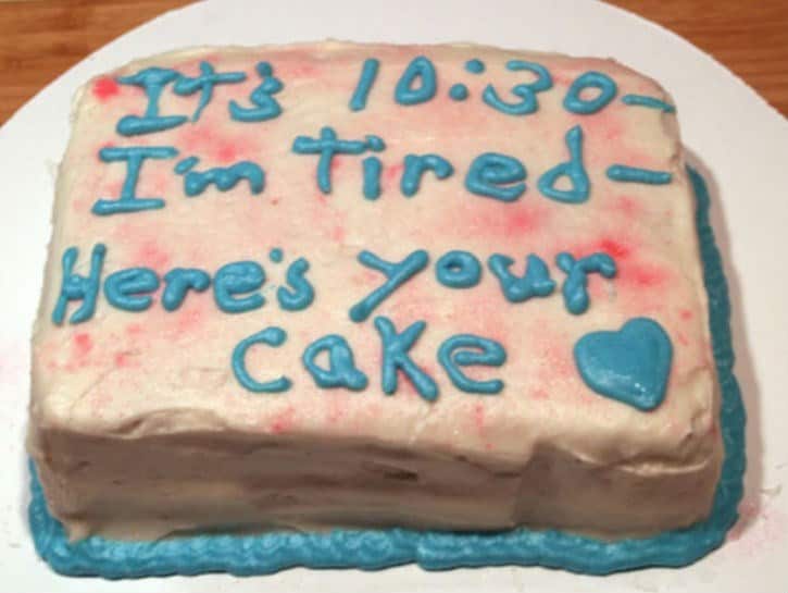 A cake fail where the decorator gave up, writing It is 10:30 I am tired Here is your cake in sloppy blue icing.