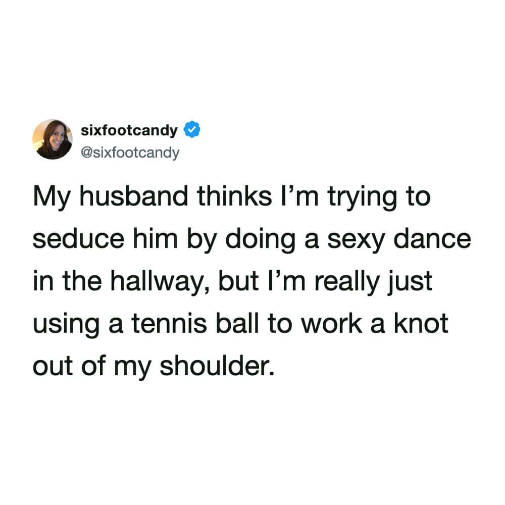 A highly relatable funny marriage meme showing a tweet where a wife explains her husband mistook her rubbing a tennis ball on a shoulder knot in the hallway for a seductive "sexy dance".