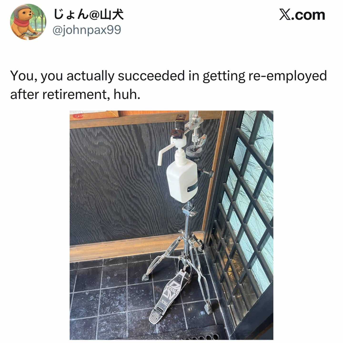 A white hand sanitizer dispenser mounted onto a professional metal drum set bass pedal.