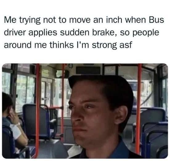 Man on a bus trying to look strong by not moving during sudden braking.