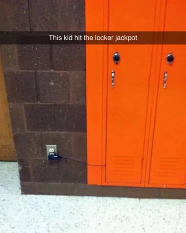 Photograph of a high school locker positioned perfectly next to a wall power outlet jackpot.