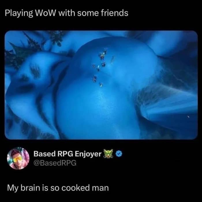 World of Warcraft snowy mountain landscape resembling a human body with players standing on the peak.