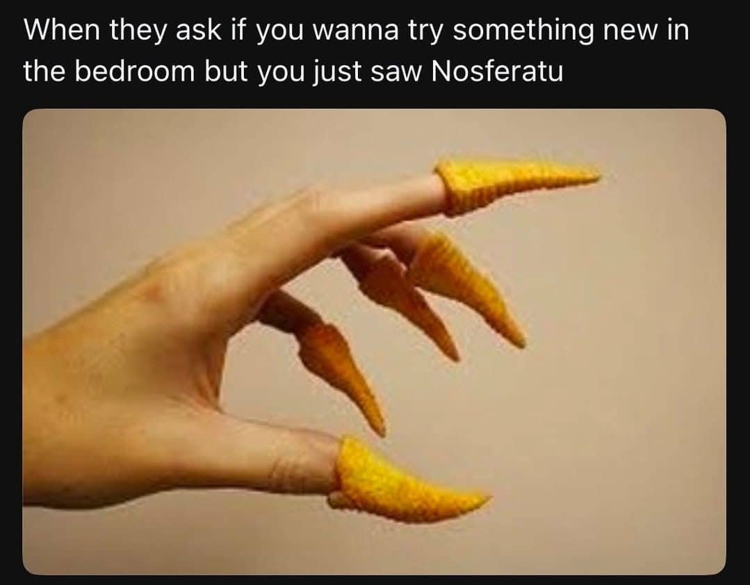 A hand with Bugles snacks placed on the fingertips to look like long, pointed monster claws.