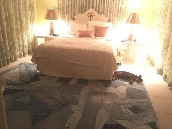 Bedroom featuring a large area rug made from a massive patchwork of various blue denim jeans.