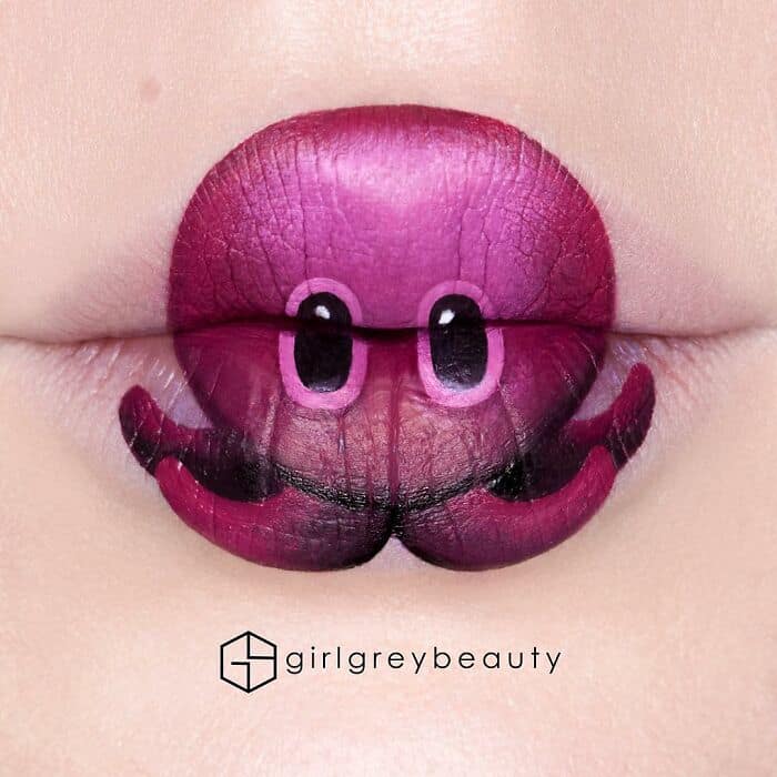 Playful and incredibly creative amazing lip art transforming the lips into a vibrant purple and magenta octopus, complete with cartoon eyes and curled tentacles extending beyond the mouth, showcasing the fun side of Andrea Reed lip art.