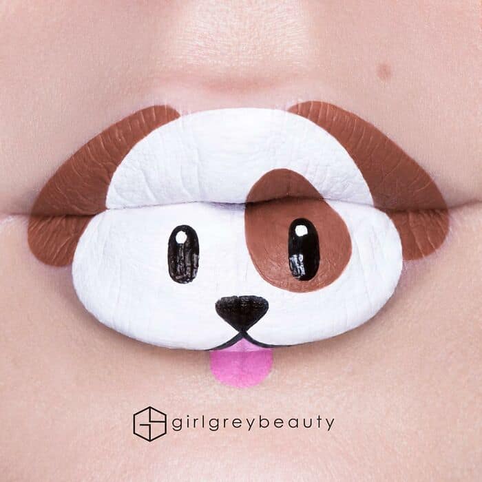 An incredibly cute and playful amazing lip art design of a white and brown puppy face with a tiny pink tongue sticking out, highlighting the whimsical side of Andrea Reed lip art.
