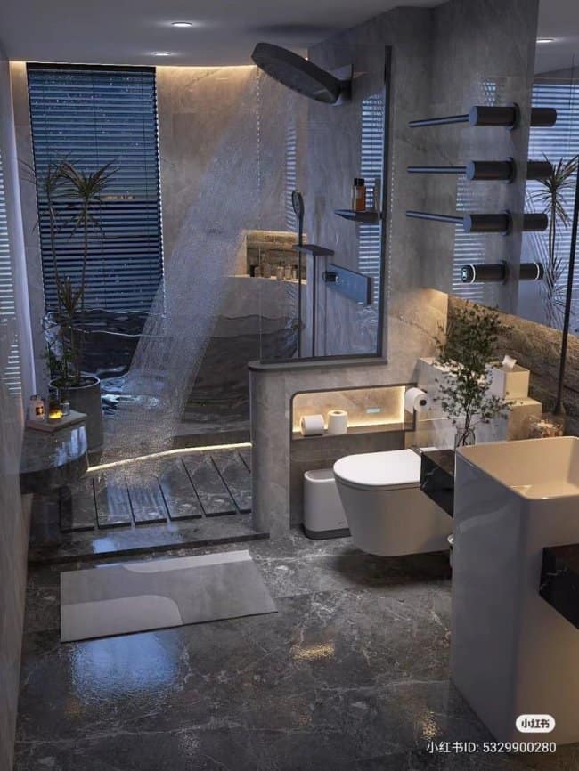 A sleek, moody masculine home decor bathroom design using dark grey stone tiles, ambient shelf lighting, and a modern glass shower enclosure for a spa-like feel.