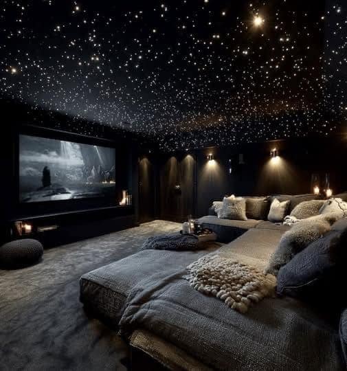 A dreamy awesome home decor cinema room featuring a fiber-optic "starry night" ceiling and a massive plush grey sectional sofa for the ultimate movie night experience.