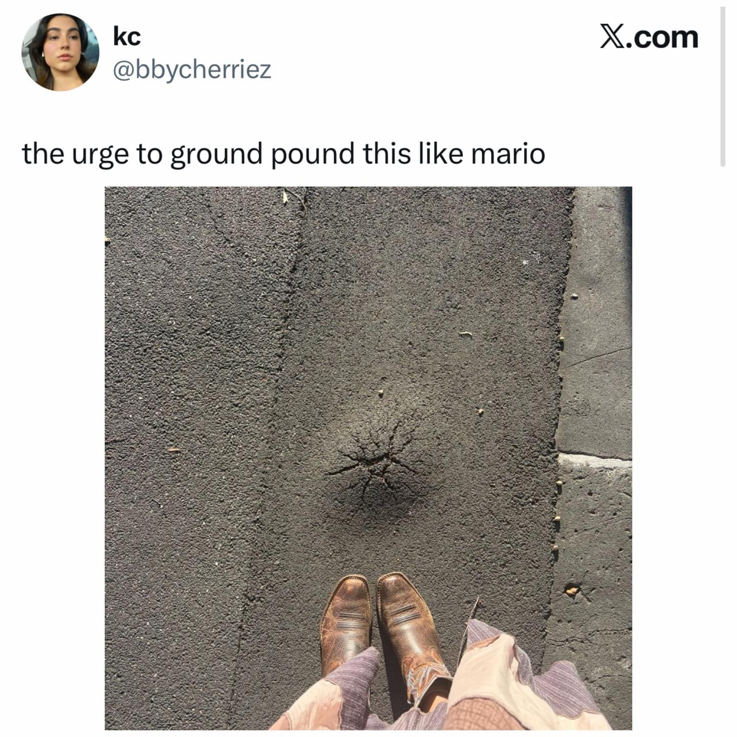 A relatable gaming-inspired entry into these hilarious memes, showing a person looking down at a perfectly cratered crack in the asphalt and feeling the undeniable "urge to ground pound this like mario."