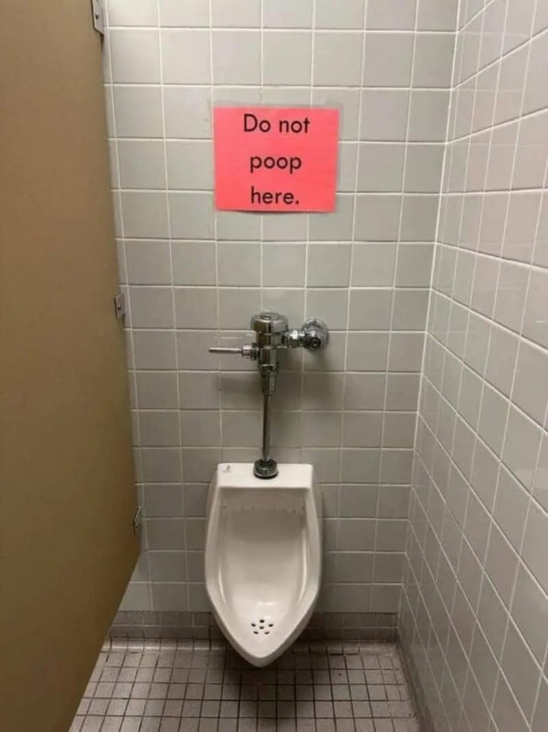 A deeply concerning public restroom funny meme showing a standard urinal with a bright pink warning sign explicitly begging people "Do not poop here," adding incredible chaotic energy to this meme dump.
