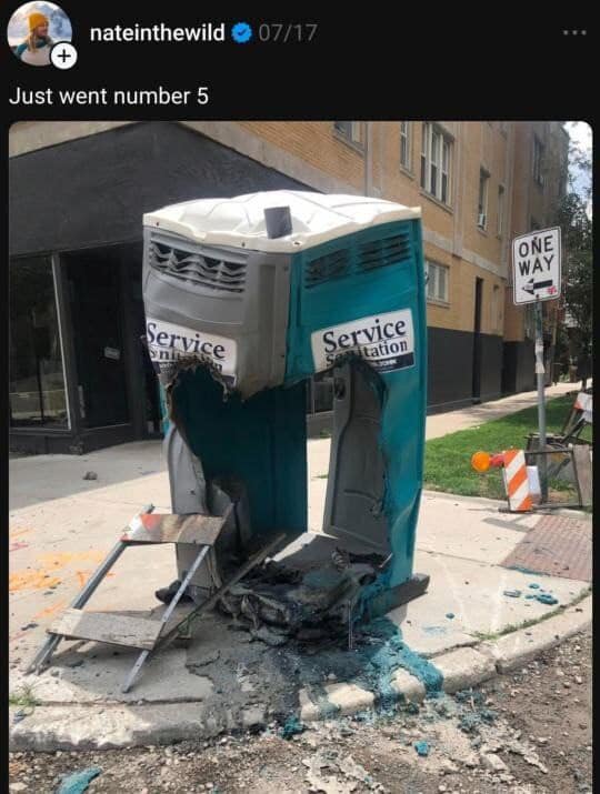 A funny meme photo of a melted and destroyed portable toilet with the caption "Just went number 5."