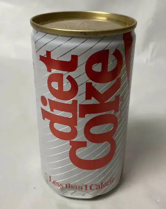 An old-school can of Diet Coke with the classic diagonal stripe design, a nostalgic drink staple found in fridges throughout the 1980s.