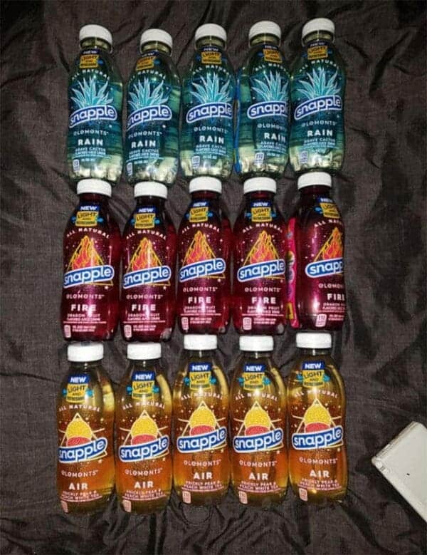 A collection of Snapple Elements bottles including Rain, Fire, and Air, a stylish nostalgic drink line known for its unique glass bottles and agave flavors.