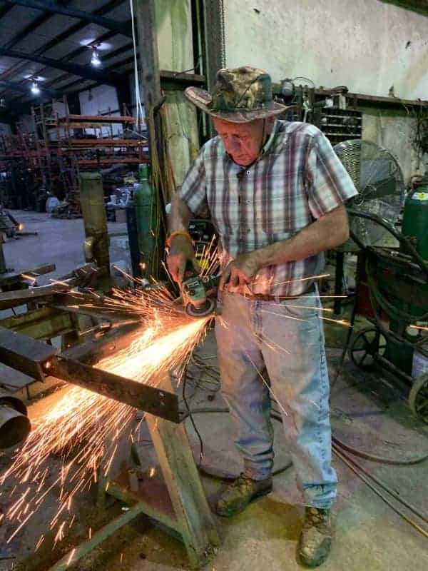 A painful osha meme depicting an older gentleman using an angle grinder with the spray of hot sparks directed precisely at his own zipper.