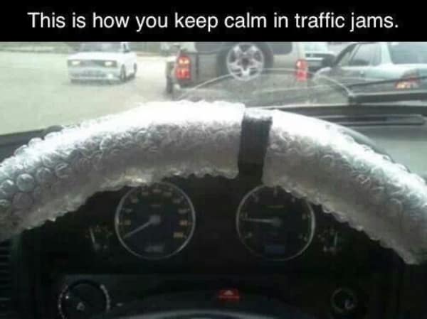 A driving meme showing a steering wheel wrapped in bubble wrap to help the driver keep calm in traffic jams.