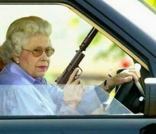 A road rage meme photoshopping Queen Elizabeth II driving a car while holding a suppressed pistol with a gangster expression.