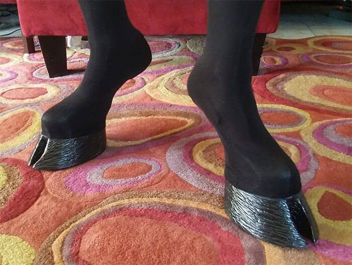 Black leggings ending in realistic cloven horse hooves instead of traditional shoes.