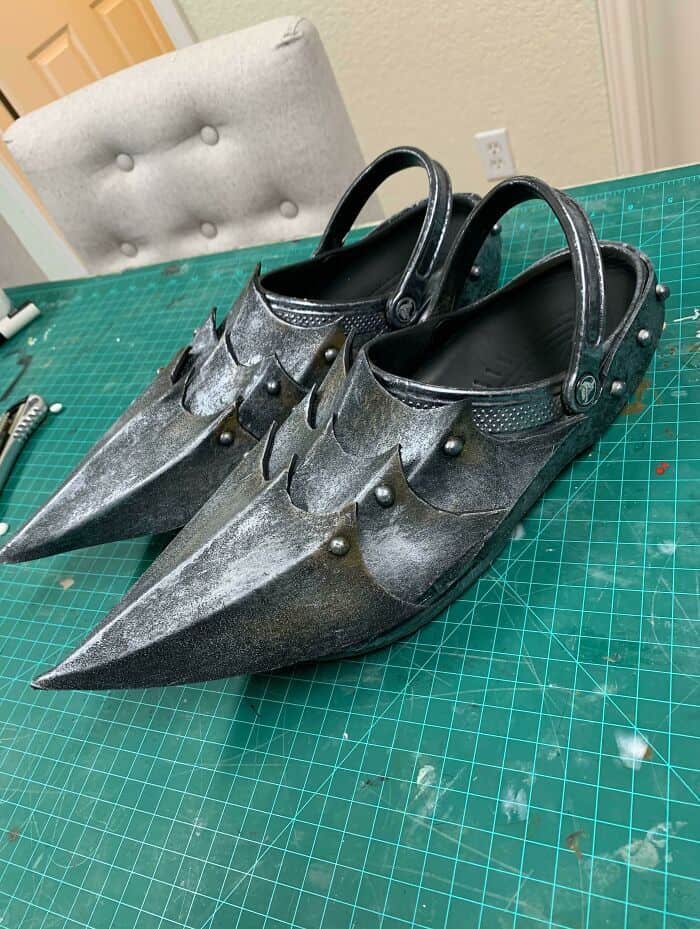 Classic Crocs modified with pointed metallic armor plating to look like medieval knight sabatons.