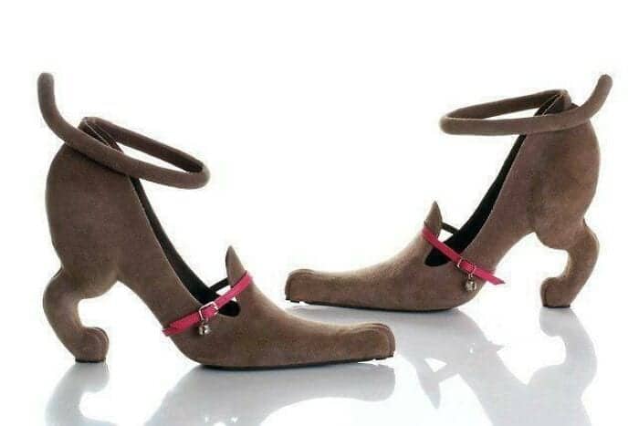 Brown suede heels shaped like a four-legged animal with a tail-loop ankle strap and a pink collar.