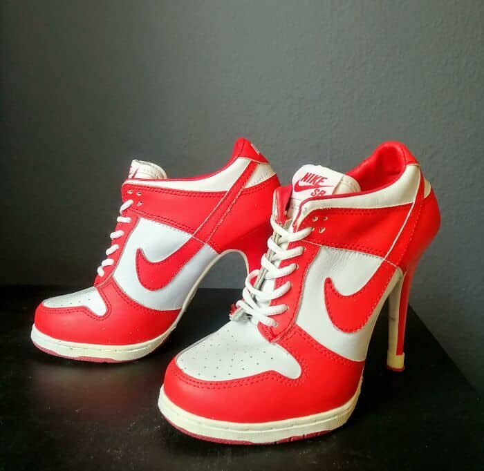 Red and white Nike Dunk sneakers converted into high heels with a thin stiletto point.