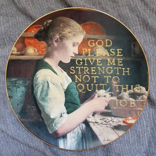 Vintage style plate depicting a girl peeling potatoes with text asking God for strength at work.
