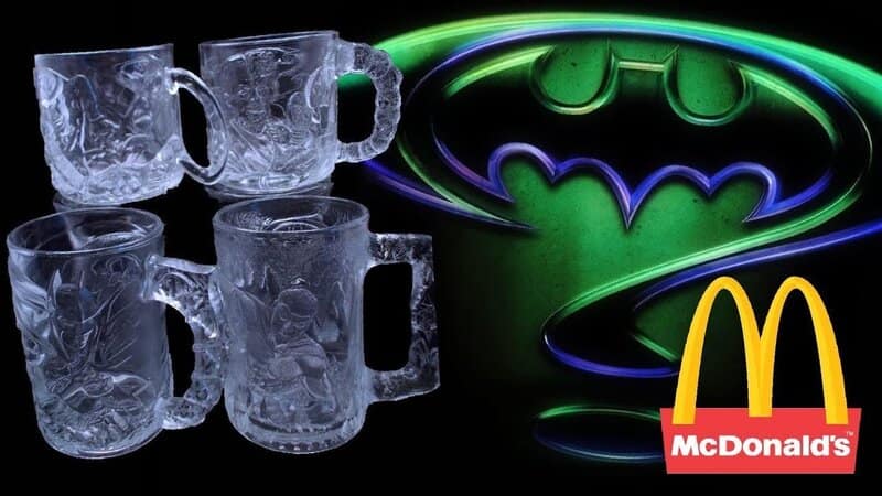 A vintage McDonalds image displaying a set of clear glass Batman Forever mugs featuring Two-Face and The Riddler.