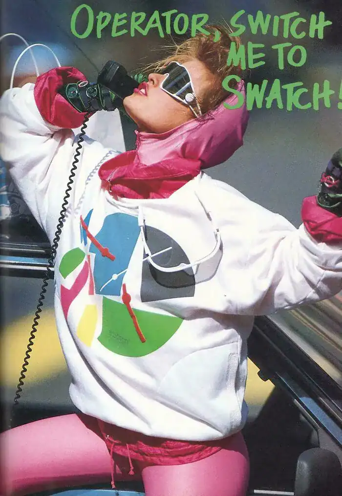 An 80s Swatch advertisement featuring a woman in bright pink and white streetwear using a corded phone.