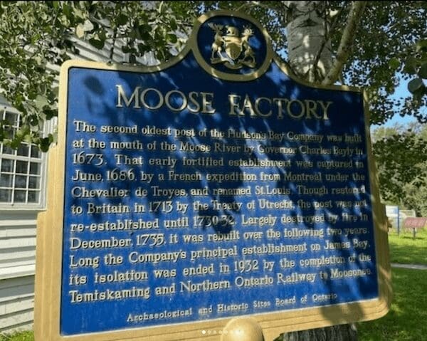 Blue historical plaque for Moose Factory Ontario explaining the Hudson's Bay Company trading post history.