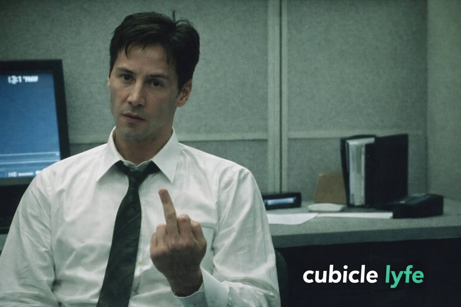 Keanu Reeves as Neo in a cubicle showing the middle finger with the text cubicle lyfe.