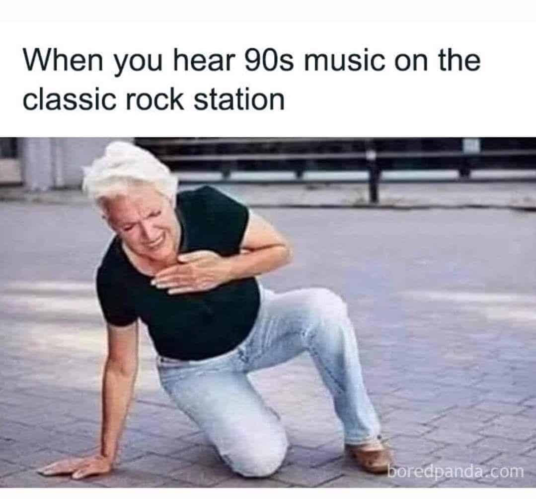 An existential 90s meme featuring a stock photo of an elderly woman clutching her heart in distress with the caption: "When you hear 90s music on the classic rock station."