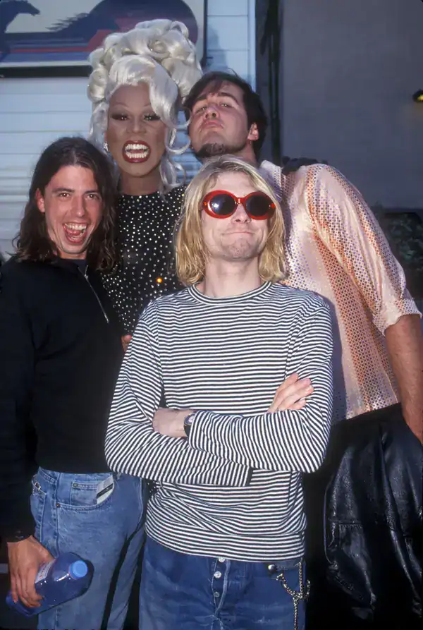 legendary moment in 90s pictures featuring Nirvana's Dave Grohl, Kurt Cobain, and Krist Novoselic posing playfully backstage alongside the iconic drag queen RuPaul in full glamour.