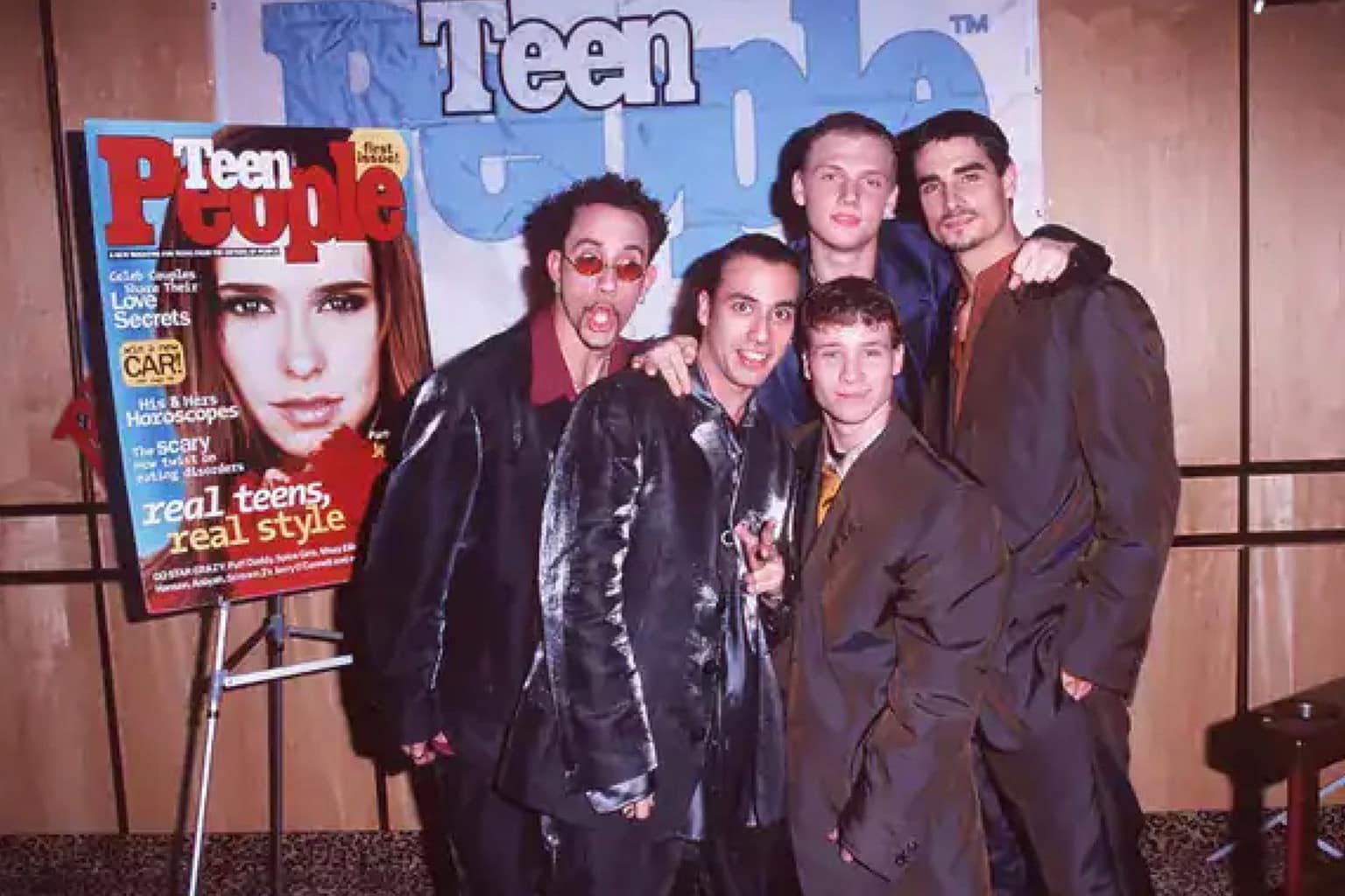 90s pictures compilation: A collage featuring the cast of Step by Step with Steve Urkel, a classic Lunchables meal with a Kool-Aid Jammers juice box, and a customer buying a Tamagotchi at a Toys 'R' Us counter.