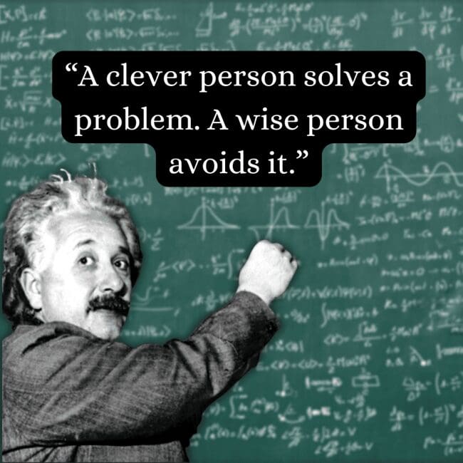 Distinguishing between quick fixes and true foresight, this albert einstein quote about cleverness versus wisdom is displayed over a rare photo of the physicist actively writing equations on a chalkboard with a piece of chalk.
