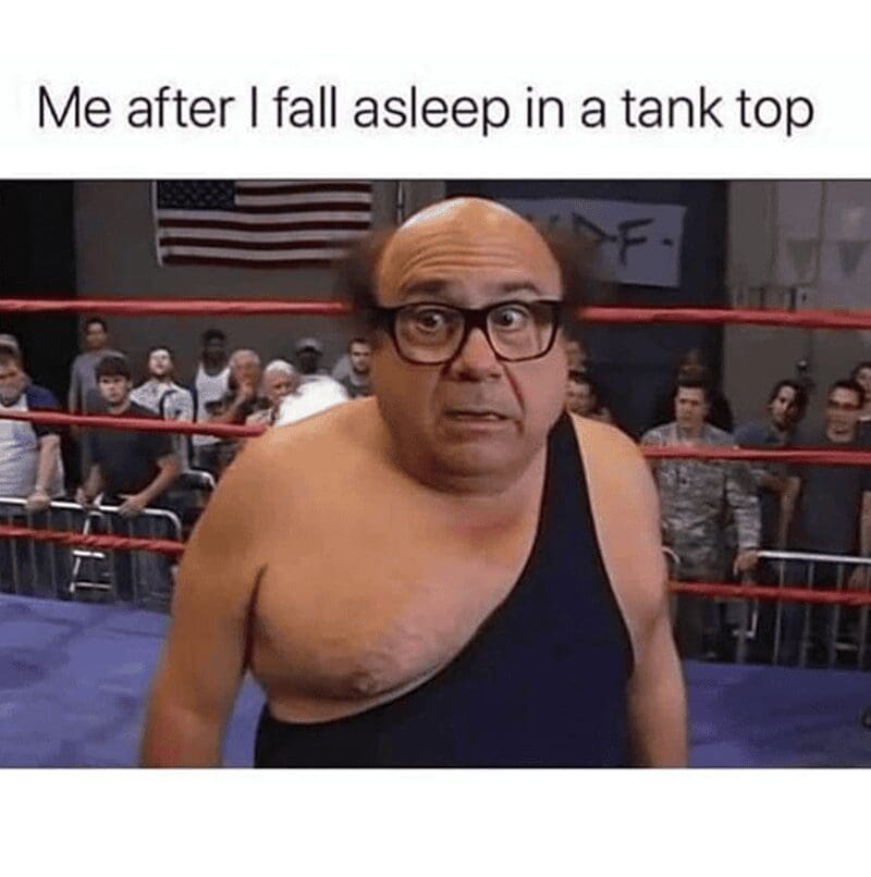 Frank Reynolds wearing a black wrestling singlet with one strap down, looking disheveled and completely confused.